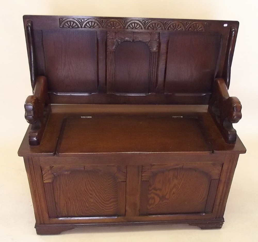 An oak monks bench with lion form handles