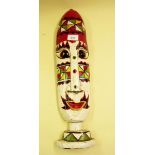 A painted and carved tribal mask - 52cm
