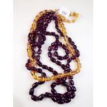 Two simulated cherry amber necklaces, a simulated yellow amber necklace and a chip amber bracelet