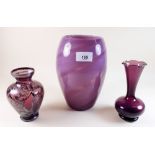 A purple glass vase with pontil mark to base and two other purple vases