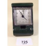 An Art Deco green leather cased eight day travel clock