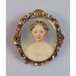 An early 19th century watercolour miniature portrait of a young girl, in yellow metal scrollwork
