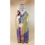 A large early 20th century Chinese famille rose figure of Shoulau, the face originally having real