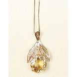 A yellow metal filigree pendant set large citrine