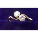 An 18 carat gold two stone diamond crossover ring - size P