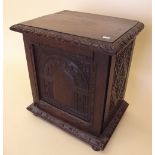 A Victorian carved oak table top cabinet enclosing four drawers