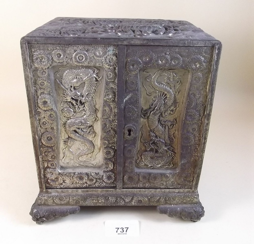 A Japanese antimony two door table top cabinet with chrysanthemum decoration enclosing four