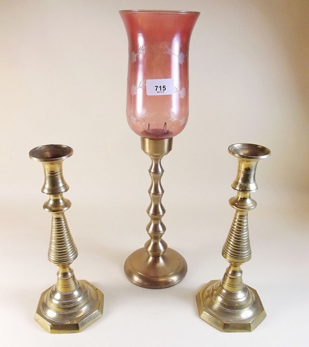 A brass candle lamp and pair of brass candlesticks
