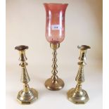 A brass candle lamp and pair of brass candlesticks