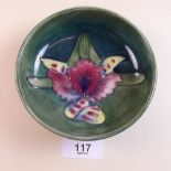 A Moorcroft pin dish painted Iris on a green ground - 11cm dia