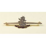 A gold and enamel diamond set military bar brooch