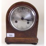 A small walnut Westminster chiming arch top mantel clock