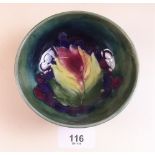 A Moorcroft pin dish painted leaves and berries on a green ground - 11cm dia
