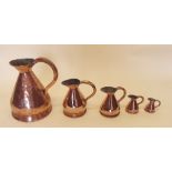 A group of five copper measures - the largest 29cm tall