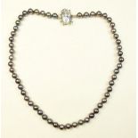 A black pearl necklace with 14K white gold clasp