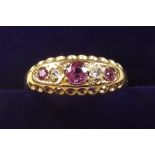 An 18 carat gold ruby and chip diamond gypsy ring - size 0