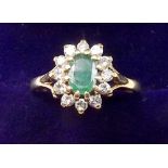 An 18 carat gold emerald and diamond cluster ring - size O