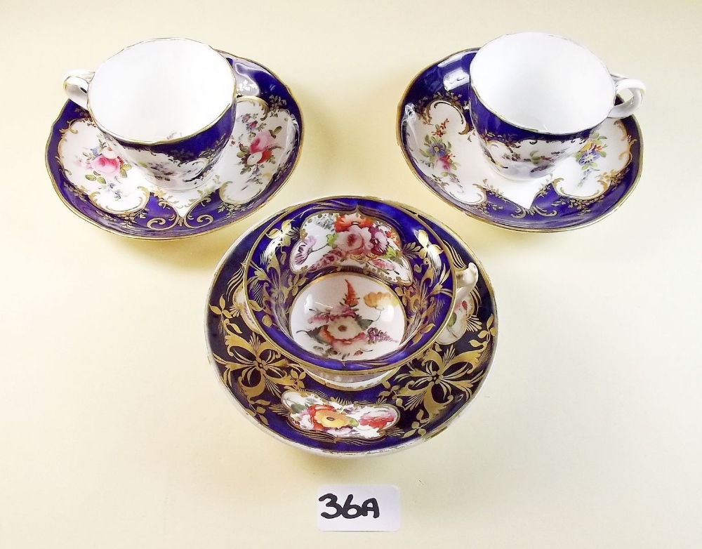 Three decorative floral painted Victorian cups and saucers