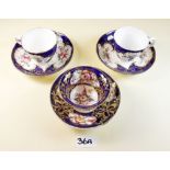 Three decorative floral painted Victorian cups and saucers