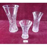 A tall cut glass vase and two other cut glass vases