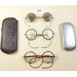 Two pairs of horn rimmed spectacles and another pair