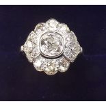 An 18 carat white gold ring set old cut diamonds - the central stone just under 1 carat - size L