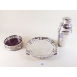 A silver plated cocktail shaker, bottle coaster and small salver