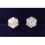 A pair of rhodium plated 9 carat gold diamond cluster earrings (with silver backs)