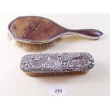 A silver and tortoiseshell hair brush and a silver backed brush