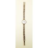 A ladies 9 carat gold wrist watch with 9 carat gold fancy link strap, by W H Wilmot - total weight