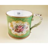 A Victorian Coalport style mug painted roses and exotic bird on green ground