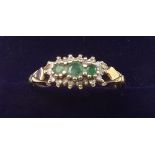 A 9 carat gold ring set three emeralds - size Q