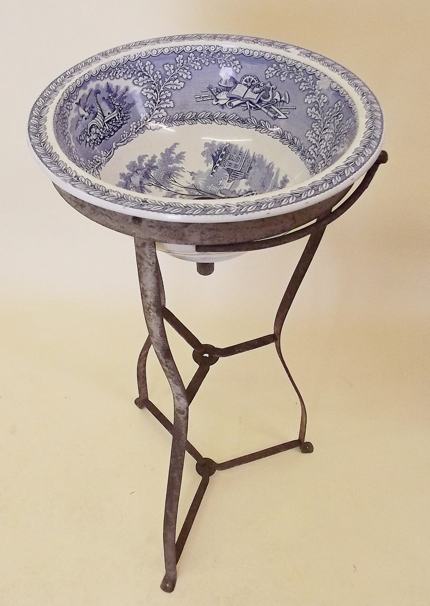 A 19th century blue and white pottery wash basin on metal stand
