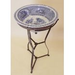 A 19th century blue and white pottery wash basin on metal stand