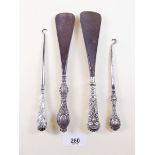 Four silver button hooks/shoe horns