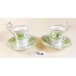 A pair of George Jones 'Crescent' china cups and saucers painted roses on a green ground