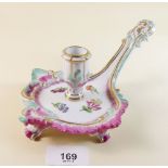 A Meissen porcelain long handled chamber stick, painted flowers with puce and turquoise borders,