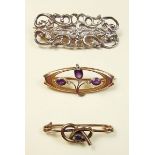 An Edwardian 9 carat gold brooch set amethyst and seed pearls and two other brooches