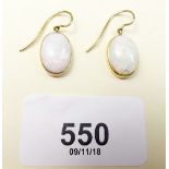 A pair of opal and gold drop earrings