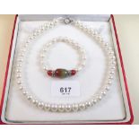 A Chinese pearl necklace and bracelet - boxed