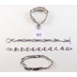 A silver gatelink bracelet and three others