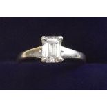 A platinum solitaire diamond ring, the emerald cut stone 0.73 carats, with receipt and certificate