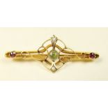 An Edwardian gold brooch set peridot and amethyst