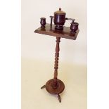 A Victorian walnut smokers stand with turned column fitted tobacco jar, pipe rack etc