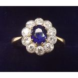 An 18 carat gold sapphire and diamond cluster ring, size O