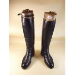 A pair of black leather ladies riding boots with pair of vintage beech boot trees, size 5