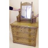 A Victorian pine dressing chest with swing mirror over two short and two long drawers