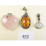 Two stone set silver pendants and an amber and silver pendant