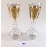 A pair of Edwardian gilded glass bud vases with star cut bases, 15cm tall