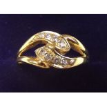 An 18 carat gold and diamond double crossover ring - size L